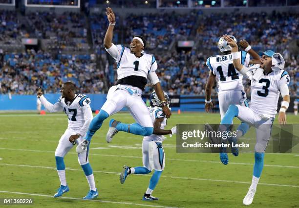 Teammates Cam Newton, Joe Webb and Derek Anderson of the Carolina Panthers react after a play during their game against the Pittsburgh Steelers at...