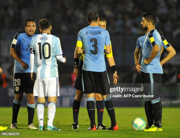 Argentine Lionel Messi argues with Uruguay's Alvaro Gonzalez next to Uruguay's Diego Godin and Luis Suarez during their 2018 World Cup qualifier...