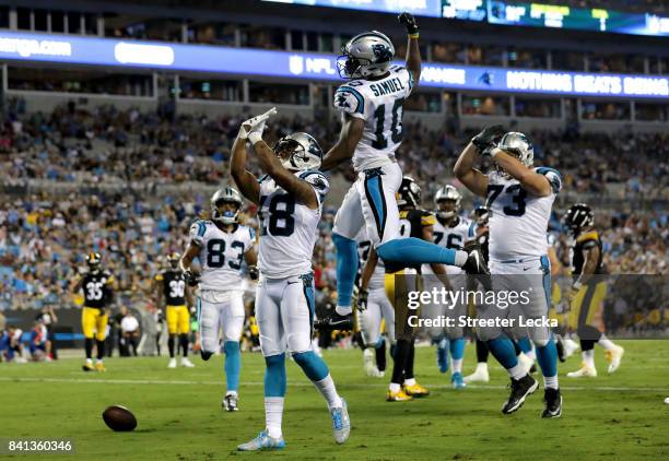 Damiere Byrd of the Carolina Panthers celebrates after scoring a touchdown with teammate Curtis Samuel of the Carolina Panthers during their game...