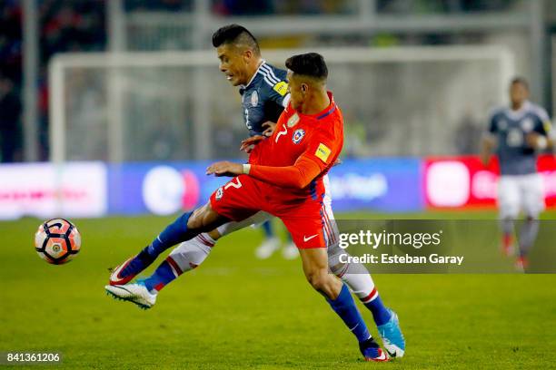 Alexis Sanchez of Chile fights for the ball with Jorge Moreira of Paraguay during a match between Chile and Paraguay as part of FIFA 2018 World Cup...