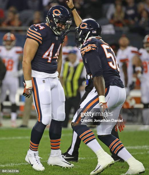 Nick Kwiatkoski of the Chicago Bears celebrates a sack with teammate Christian Jones against the Cleveland Browns during a preseason game at Soldier...