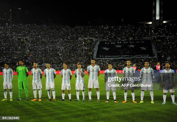 Players of Argentina listen to their national anthem before the start of the 2018 World Cup football qualifier match against Uruguay in Montevideo,...