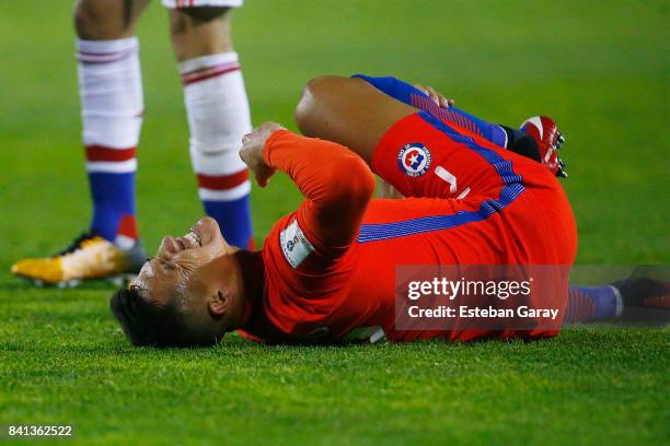 Alexis Sanchez of Chile lies in pain during a match between Chile and Paraguay as part of FIFA 2018 World Cup Qualifiers at Monumental Stadium on...