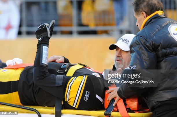 Quarterback Ben Roethlisberger of the Pittsburgh Steelers gives a thumbs up signal as he is carted off the field after he was injured during a game...