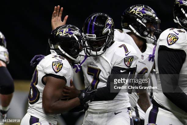 Thad Lewis of the Baltimore Ravens and Bobby Rainey of the Baltimore Ravens celebrate after a touchdown against the New Orleans Saints at...