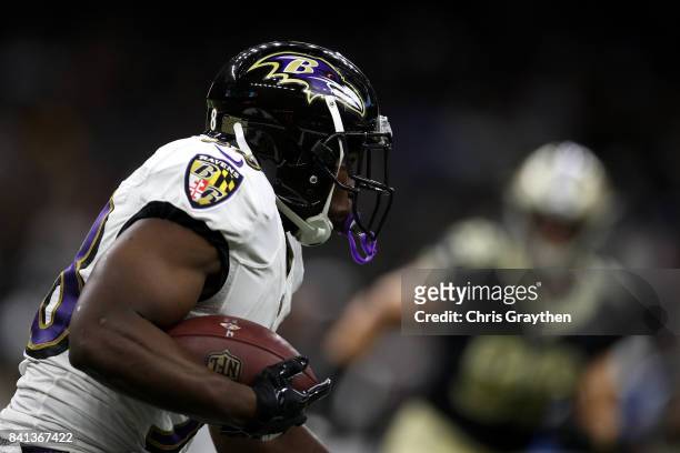 Bobby Rainey of the Baltimore Ravens runs with the ball against the New Orleans Saints at Mercedes-Benz Superdome on August 31, 2017 in New Orleans,...