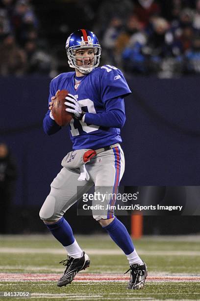 Quarterback Eli Manning of the New York Giants goes back to pass during a NFL game against the Carolina Panthers on December 21, 2008 at Giants...