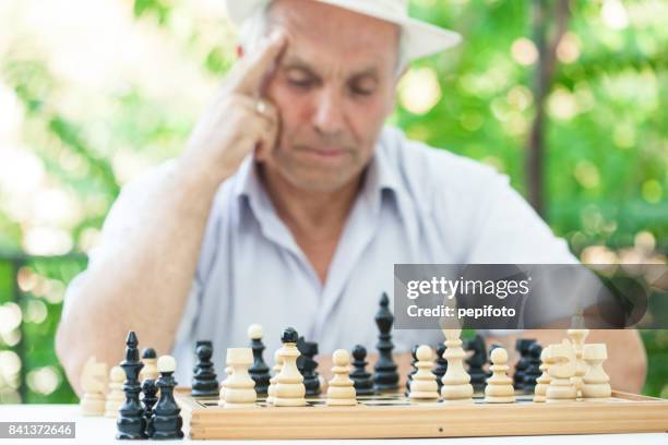 anciano jugando al ajedrez - banco de jogadores fotografías e imágenes de stock