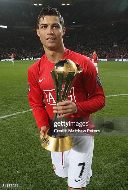 Cristiano Ronaldo of Manchester United poses with the FIFA World Club Cup trophy ahead of the Barclays Premier League match between Manchester United...