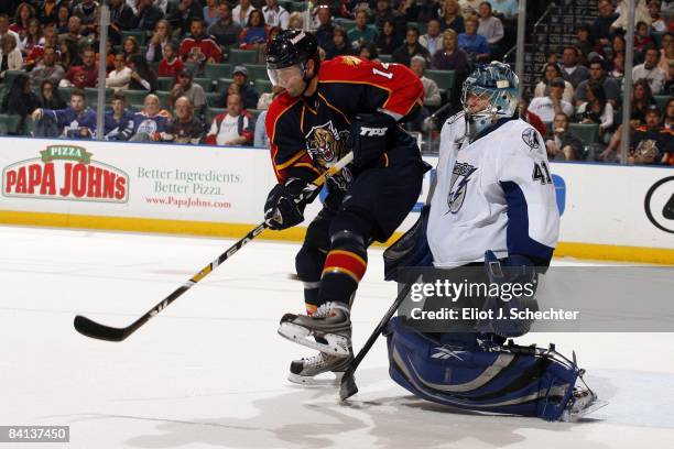 Goaltender Mike Smith of the Tampa Bay Lightning defends the net against Radek Dvorak of the Florida Panthers at the Bank Atlantic Center on December...