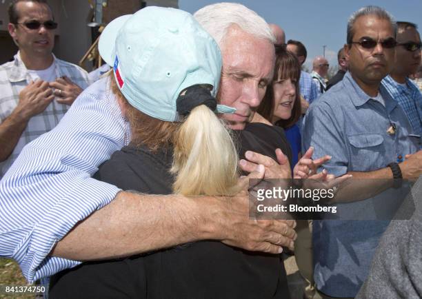 Vice President Mike Pence hugs a woman during a trip to survey the damage from Hurricane Harvey in Rockport, Texas, U.S., on Thursday, Aug. 31, 2017....