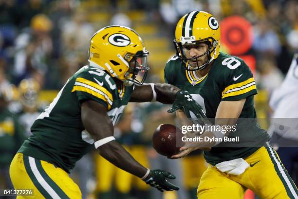 Taysom Hill of the Green Bay Packers hands the ball off to Jamaal Williams in the third quarter against the Los Angeles Rams during a preseason game...