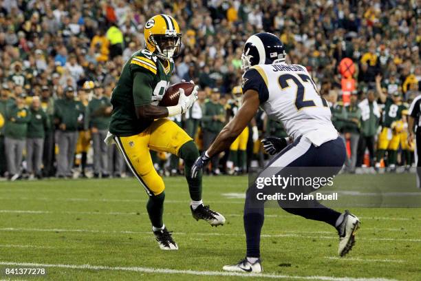 Geronimo Allison of the Green Bay Packers catches a pass in front of Isaiah Johnson of the Los Angeles Rams in the second quarter during a preseason...