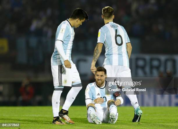 Lionel Messi of Argentina reacts after receiving a foul from Alvaro Gonzalez of Uruguay during a match between Uruguay and Argentina as part of FIFA...