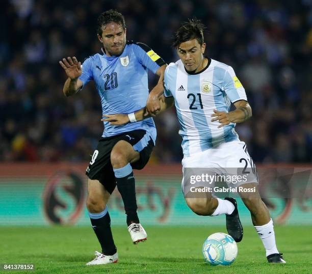 Paulo Dybala of Argentina fights for the ball with Alvaro Gonzalez of Uruguay during a match between Uruguay and Argentina as part of FIFA 2018 World...