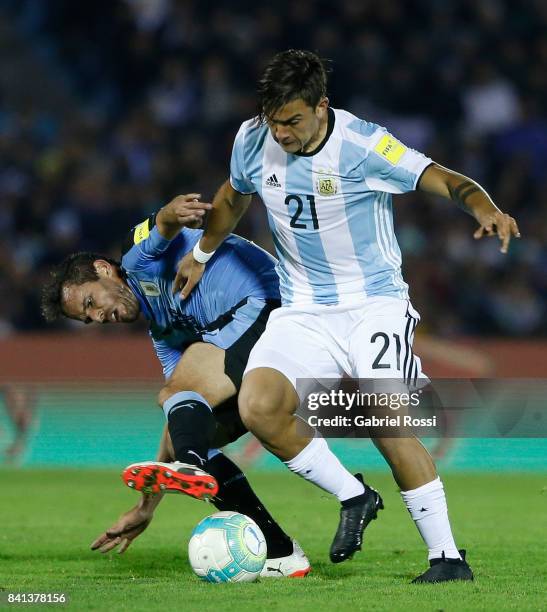 Paulo Dybala of Argentina fights for the ball with Alvaro Gonzalez of Uruguay during a match between Uruguay and Argentina as part of FIFA 2018 World...