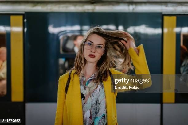 young woman in milan subway station - hair toss stock pictures, royalty-free photos & images