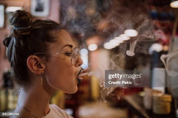 美しい女性が煙を楽しんで - electronic cigarette smoke ストックフォトと画像