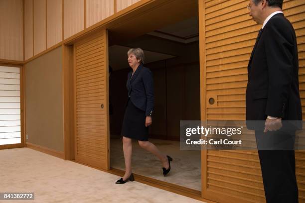 Britain's Prime Minister, Theresa May, arrives to be greeted by Emperor Akihito of Japan during her visit to the Royal Palace on September 1, 2017 in...
