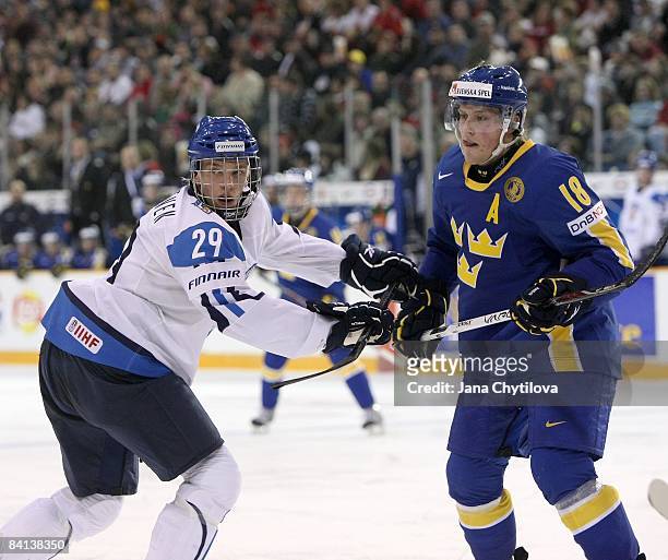 Joonas Nattinen of Team Finland battles for position against Joakim Andersson of Team Sweden during the IIHF World Junior Championships held at the...