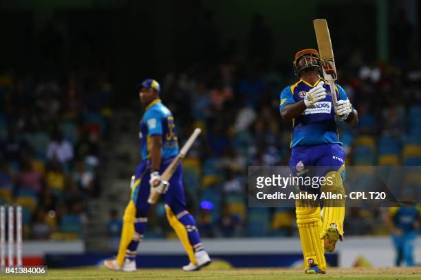 In this handout image provided by CPL T20, Dwayne Smith of Barbados Tridents reacts to the dismissal of team mate Kieron Pollard celebrate the...