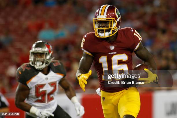 Wide receiver Zach Pascal of the Washington Redskins evades linebacker Cameron Lynch of the Tampa Bay Buccaneers during a carry in the third quarter...
