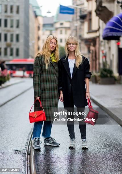 Emili Sindlev wearing olive checked wool coat, red JW Anderson bag and Jeanette Madsen on August 31, 2017 in Stockholm, Sweden.