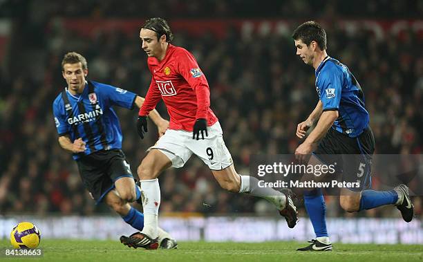 Dimitar Berbatov of Manchester United clashes with Gary O'Neil and Chris Riggott of Middlesbrough during the Barclays Premier League match between...