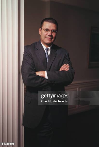 Smiling Robert McNamara stands and smiles with his arms crossed as Secretary of Defense during the Kennedy Administration, 1962. Washington, D.C.