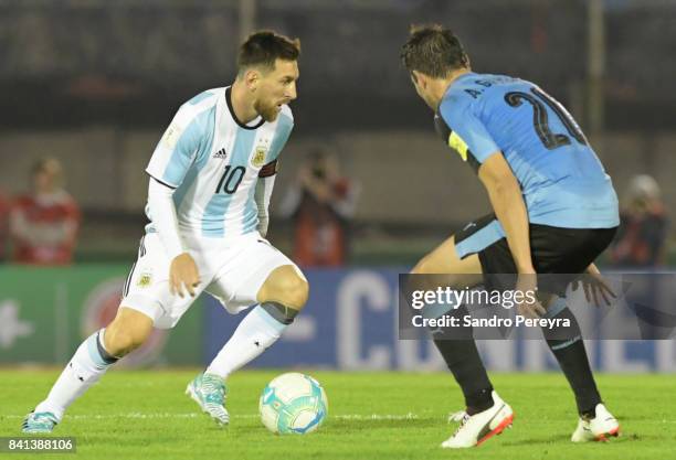 Lionel Messi of Argentina and Alvaro Gonzalez of Uruguay fight for the ball during a match between Uruguay and Argentina as part of FIFA 2018 World...