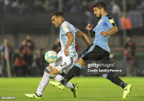 Luis Suarez of Uruguay and Gabriel Mercado of Argentina fight for the ball during a match between Uruguay and Argentina as part of FIFA 2018 World...
