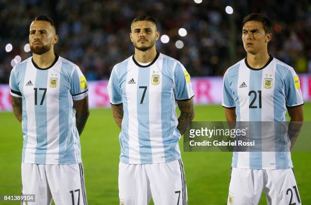 Nicolas Otamendi, Mauro Icardi and Paulo Dybala of Argentina line up for the National Anthem prior to a match between Uruguay and Argentina as part...