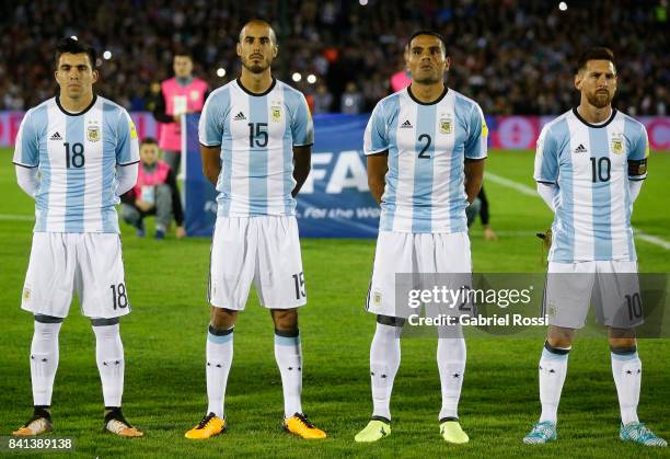 Marcos Acuña, Guido Pizarro, Gabriel Mercado and Lionel Messi of Argentina line up for the National Anthem prior to a match between Uruguay and...