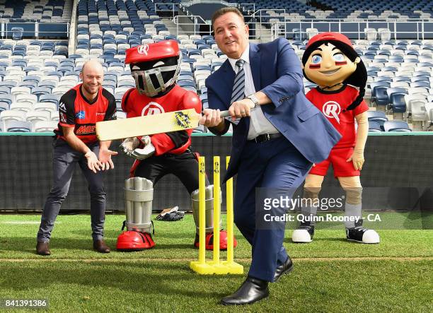 Sport Minister John Eren plays cricket with Tim Ludeman of the Renegades and the Renegades mascots during a Melbourne Renegades Big Bash League media...