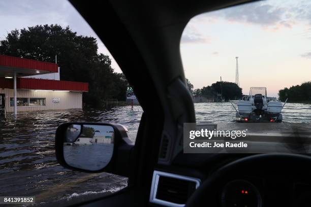 Vehicles navigate hwy 90 after parts of the road were flooded by Hurricane Harvey causing an approximately four hour west bound traffic backup on...