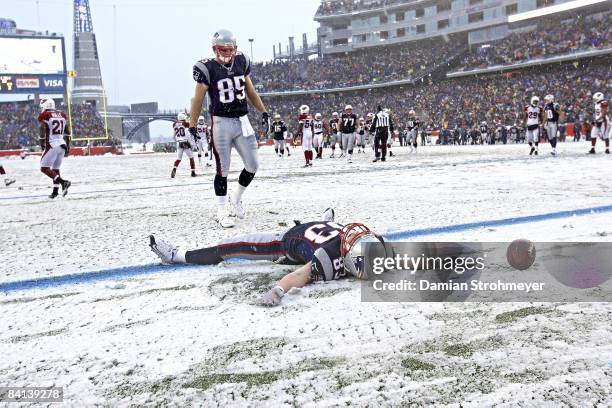 New England Patriots Wes Welker victorious, making snow angels in endzone after scoring touchdown vs Arizona Cardinals during 1st half. Foxboro, MA...