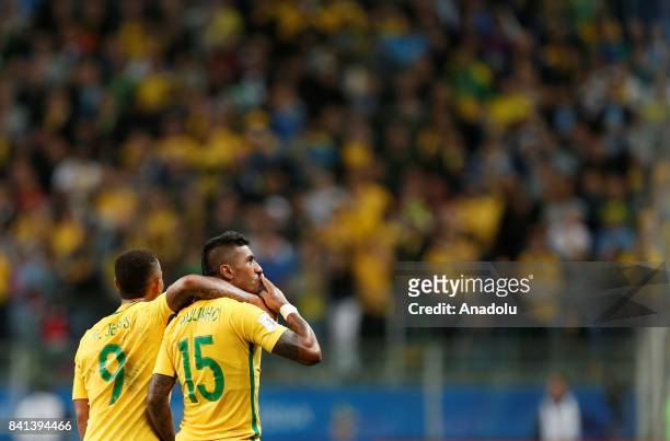 Paulinho of Brazil celebrates with his teammate after scoring a goal during the 2018 FIFA World Cup Russia qualifying match between Brazil and...