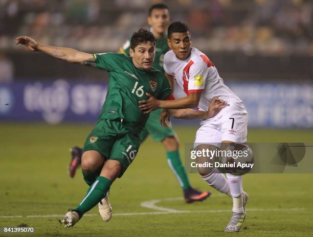 Ronald Raldes of Bolivia fights for the ball with Paolo Hurtado of Peru during a match between Peru and Bolivia as part of FIFA 2018 World Cup...