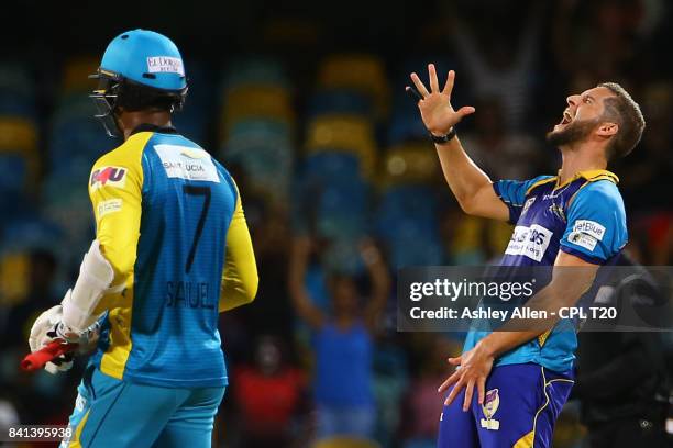 In this handout image provided by CPL T20, Wayne Parnell of Barbados Tridents celebrates the dismissal of Marlon Samuels of the St Lucia Stars during...