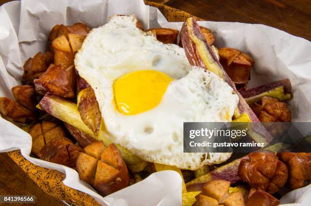 fried potatoes with fried egg and hot dog - bolivia daily life stock pictures, royalty-free photos & images