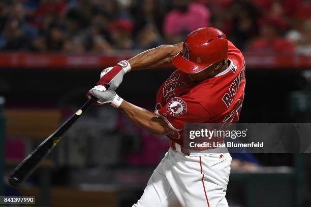 Ben Revere of the Los Angeles Angels of Anaheim hits a single in the second inning against the Texas Rangers at Angel Stadium of Anaheim on August...