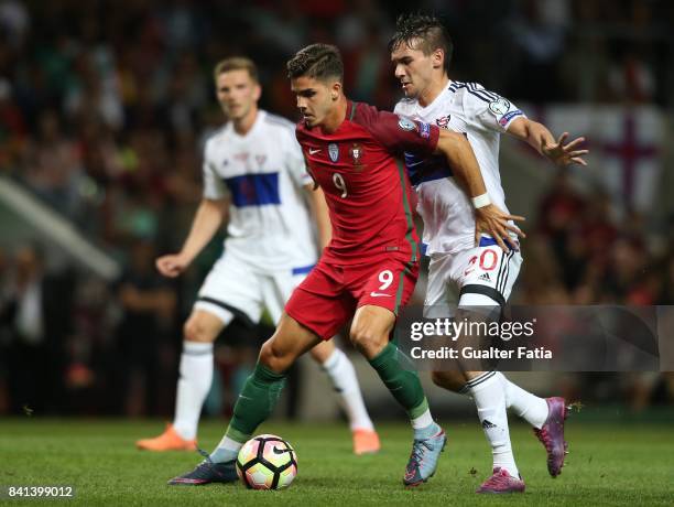 Portugal's forward Andre Silva with Faroe Island defender Rene Joensen in action during the FIFA 2018 World Cup Qualifier match between Portugal and...