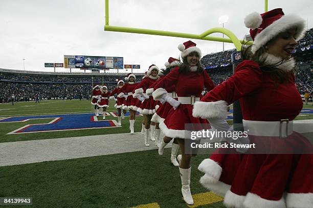 The Buffalo Jills cheerleaders run off the field before the Buffalo Bills game against the New England Patriots on December 28, 2008 at Ralph Wilson...