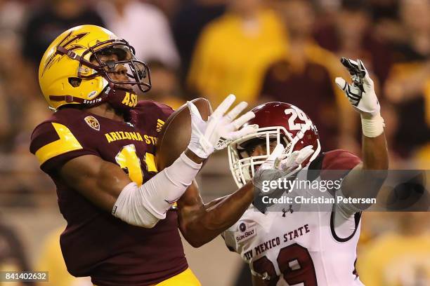 Wide receiver John Humphrey of the Arizona State Sun Devils catches a 60 yard touchdown reception past defensive back Jared Phipps of the New Mexico...