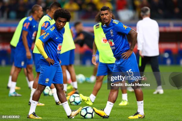 Willian and Paulinho of Brazil warm up before a match between Brazil and Ecuador as part of 2018 FIFA World Cup Russia Qualifier at Arena do Gremio...