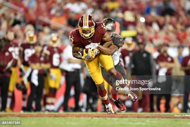 Washington Redskins wide receiver Maurice Harris is tackled by Tampa Bay Buccaneers cornerback Jonathan Moxey after a reception during an NFL...