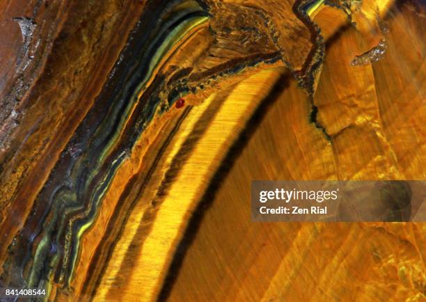 extreme close-up of tiger's eye polished gemstone - gemology stock-fotos und bilder