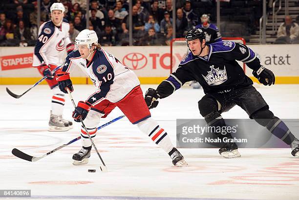 Kris Russell of the Columbus Blue Jackets drives the puck as Raitis Ivanans of the Los Angeles Kings reaches in during the game on December 29, 2008...