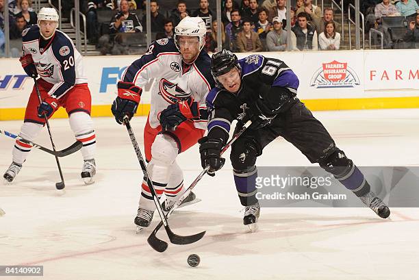 Jan Hejda of the Columbus Blue Jackets fights for the puck against Trevor Lewis of the Los Angeles Kings during the game on December 29, 2008 at...