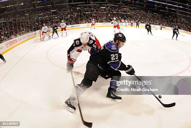 Rostislav Klesla of the Columbus Blue Jackets reaches for the puck against Dustin Brown of the Los Angeles Kings during the game on December 29, 2008...